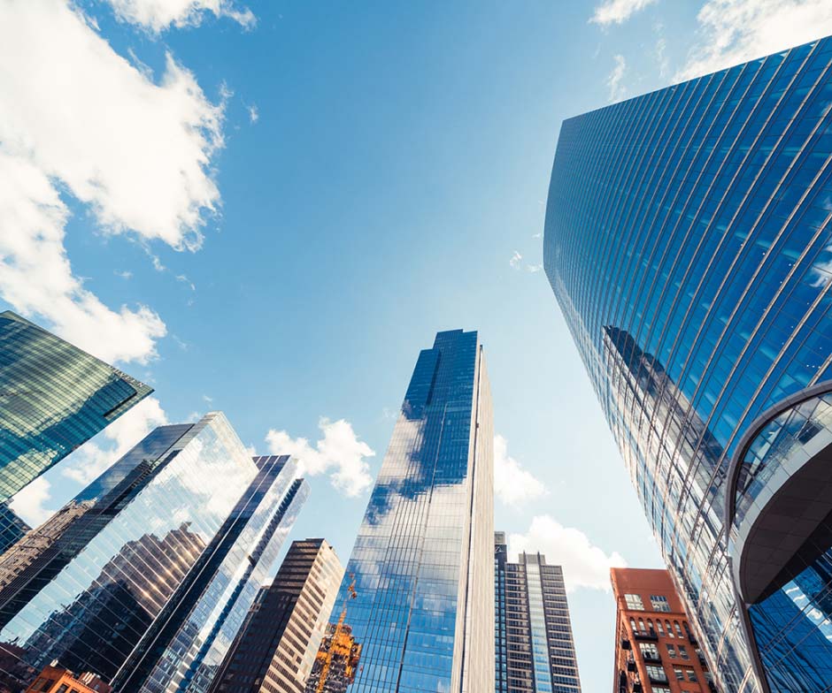 looking up at skyrise buildings and clouds