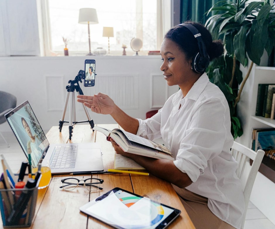 person sitting at desk having a meeting on computer