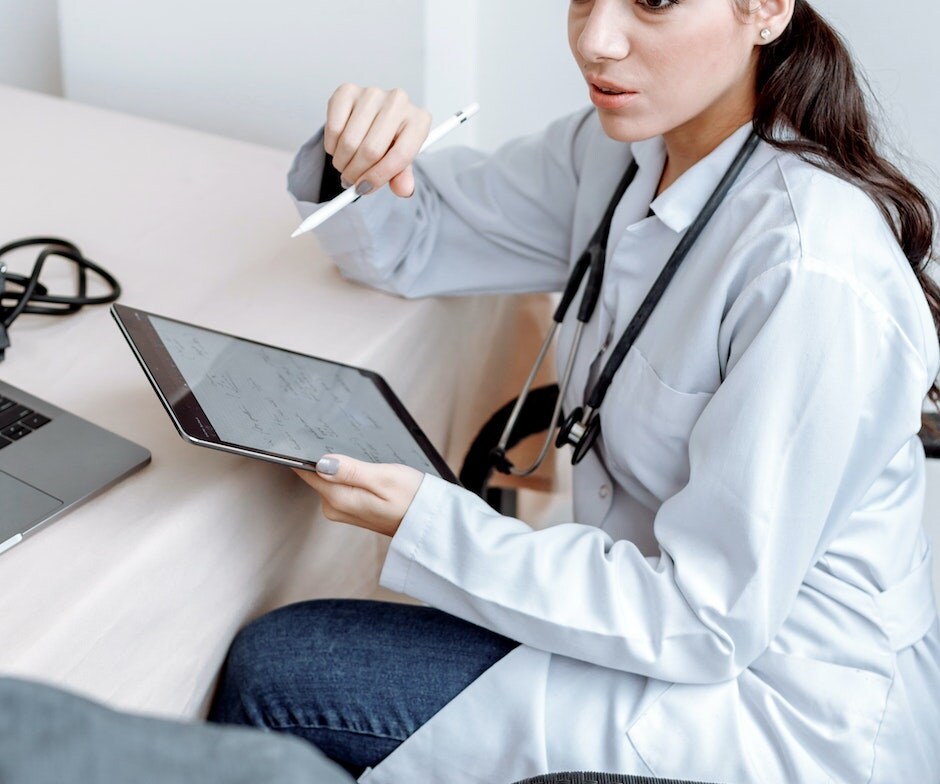 medical professional holding a tablet and stylus