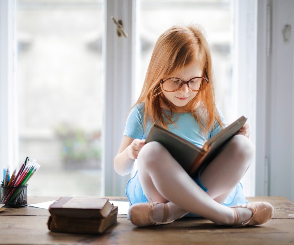 young girl reading a book