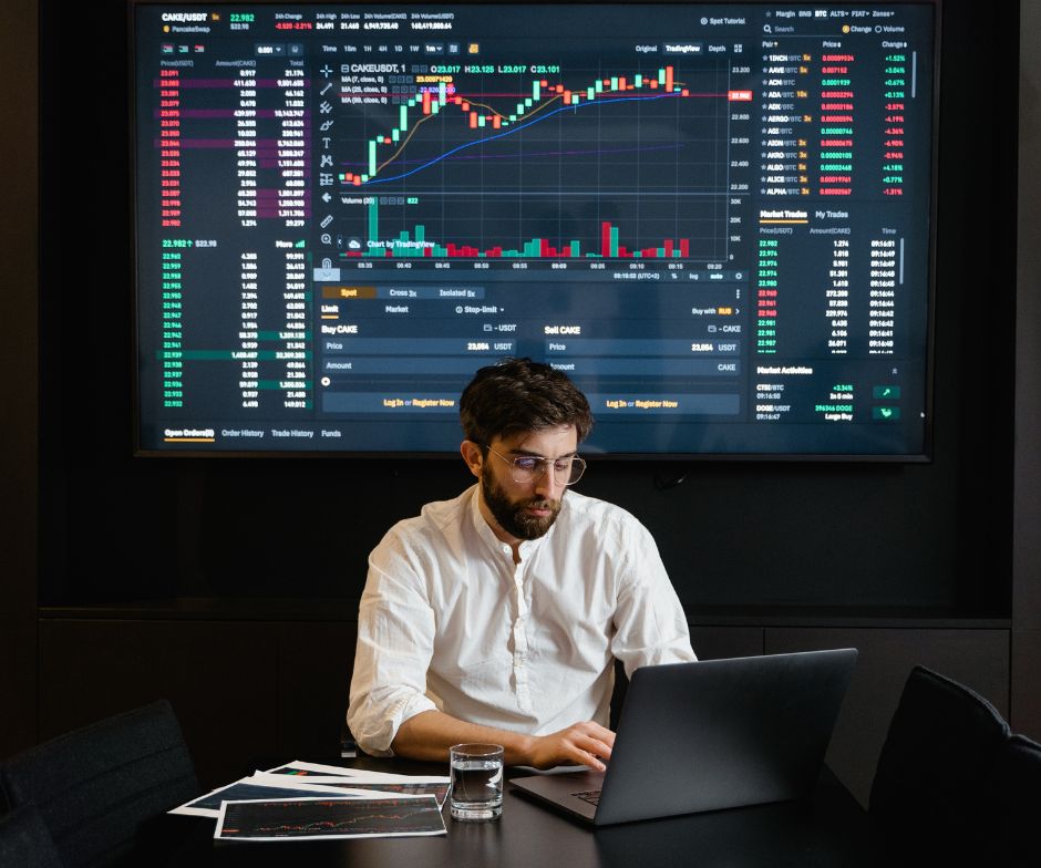 person working on front of a large screen