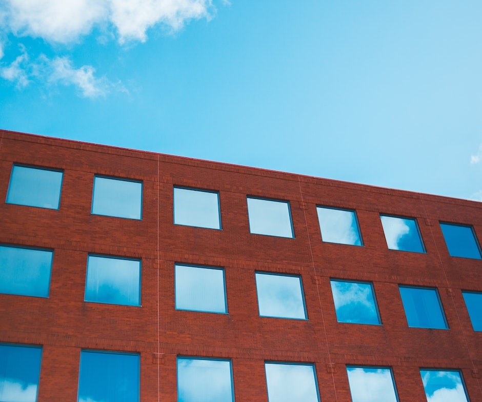 upward shot of brick building with sky in the background