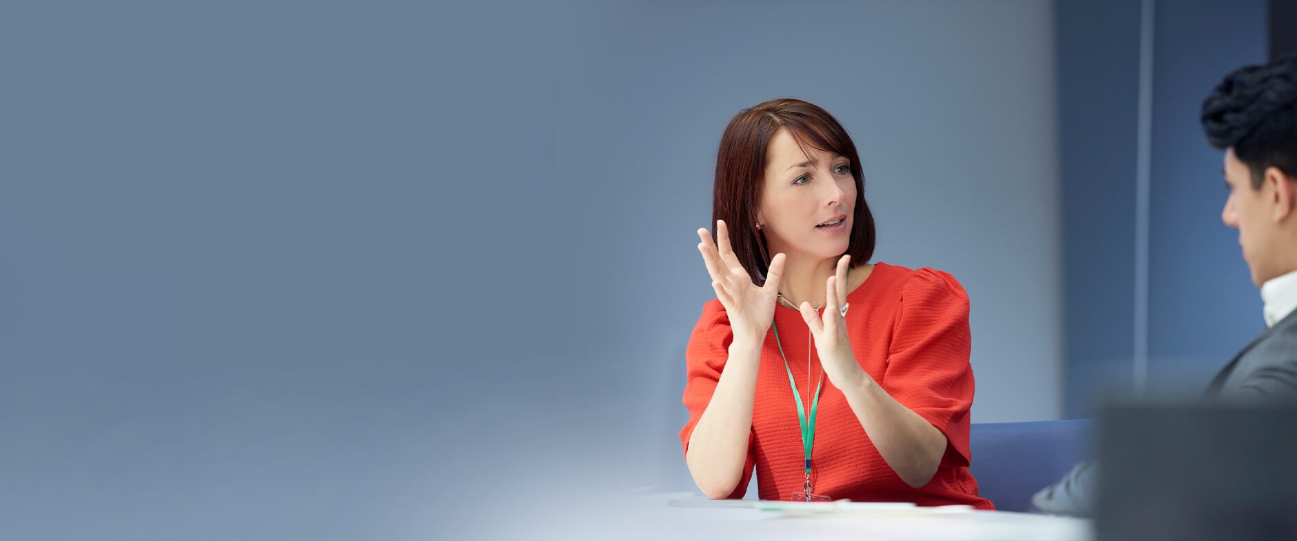 Two people in office setting discussing business