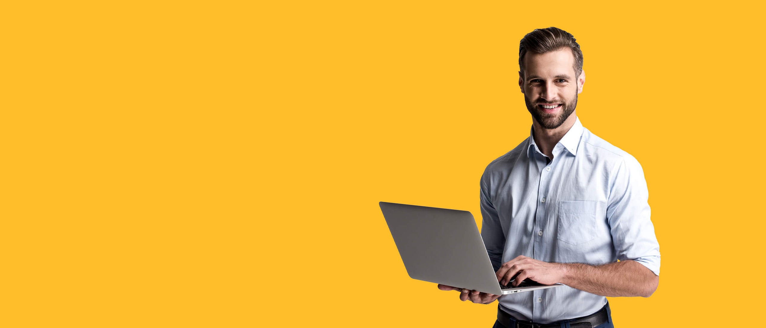 A Person standing with a laptop posing to camera 